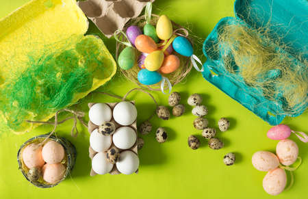 White chicken Chicken and quail eggs in colored paper eco-friendly packaging with decorative sisal. Close-up photo, macro.  Easter background. Food conceptの写真素材