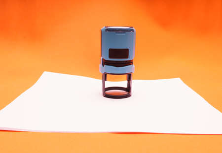 Office seal, stamp on blank white sheet of paper, close-upの写真素材