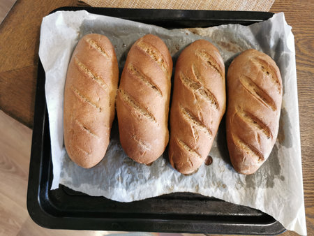Freshly baked baguettes on a baking sheet. Top view.の写真素材