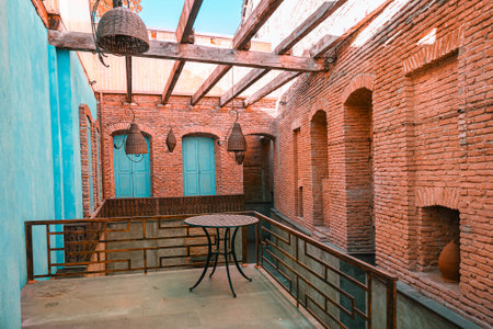 brick wall and blue doors wish table, summer cafe in anticipation of summer in the old city of...