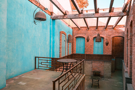 brick wall and blue doors wish table, summer cafe in anticipation of summer in the old city of Tbilisiの写真素材