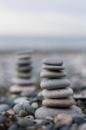 towers made of stones on the seashore. 2 towers, Black Sea shore. Batumi, Georgia. photo in shades...