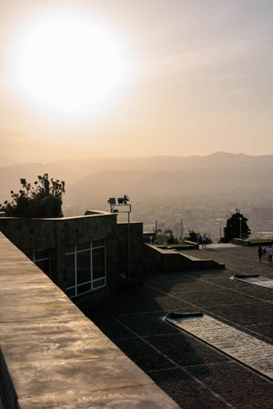 View of Tbilisi at sunset from the Chronicle of Georgia monument. The golden light illuminates the...