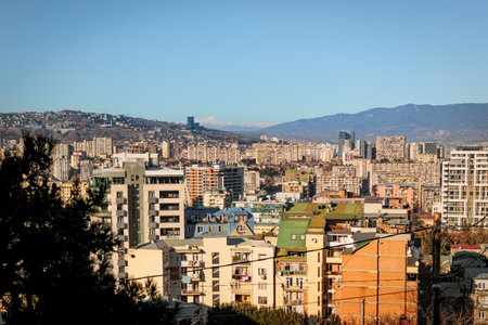 Panoramic view of a vibrant cityscape with colorful residential buildings, high-rise apartments, and...