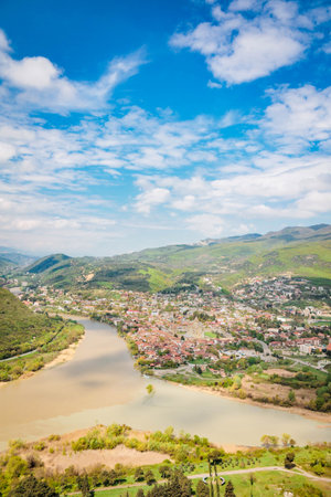 Vertical panoramic view of Mtskheta town and the confluence of Aragvi and Kura rivers, captured from Jvari Monastery, Georgia, in springの写真素材