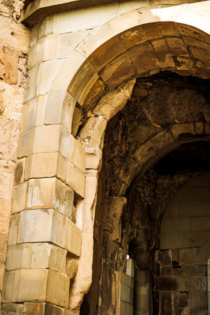 Architectural detail of a stone archway at the ancient Jvari Monastery, highlighting medieval masonry, near Mtskheta, Georgiaの写真素材