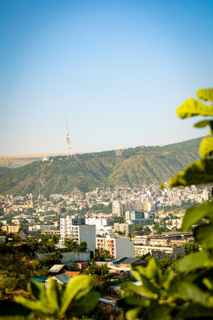 Morning panorama of Tbilisi, Georgia, with Mtatsminda TV Tower and hillside skyline framed by...