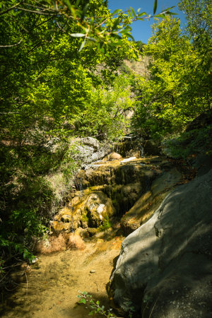 Hidden forest waterfall near Mtskheta, Georgia, surrounded by mossy rocks and green trees. Ideal for spa branding, eco-tourism content, or relaxing nature visualsの写真素材