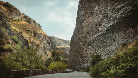 Wide view of the Symphony of Stones in Garni Gorge, Armenia. Volcanic basalt cliffs line the...