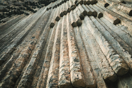 Close-up view of vertical basalt columns in Garni Gorge, Armenia. The natural volcanic formation...