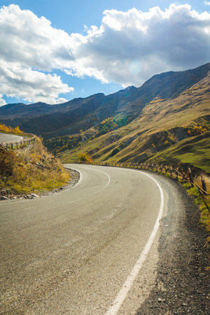 Serpentine road leading through the Caucasus mountains in Georgia during bright autumn. Scenic,...