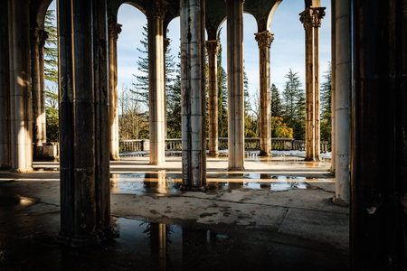 Arched columns of the abandoned Medea Sanatorium in Tskaltubo, Georgia. Winter light, decaying elegance, and classical architecture evoke a haunting beauty of forgotten grandeurの写真素材