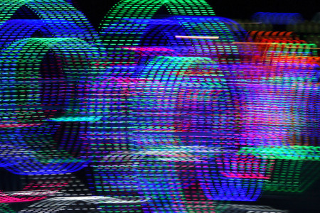 Abstract background of blurred multicolored dotted lines on dark background.の写真素材