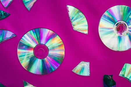 Vintage CD or DVD disk background, old circle discs and treir parts used for data storage, share movies and music.の写真素材