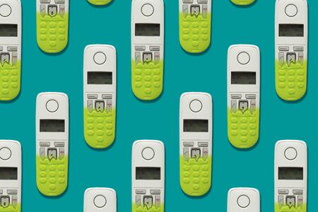 Pattern image of DECT phones turning into a toy phones on blue background. The concept of technology obsolescence.の写真素材