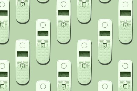 Pattern image of DECT phones turning into a toy phones on trendy mint background. The concept of technology obsolescence.の写真素材