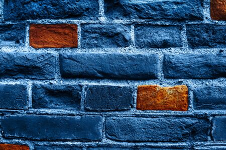 Close up image of old brick wall in blue color with some orange bricks. Background.の写真素材