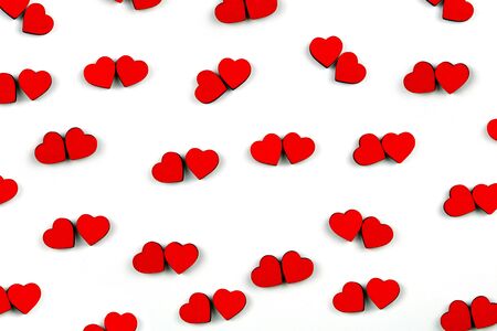 Pattern of a lot of small red hearts isolated on white background. Hearts are located by couples. Concept of love. Flat lay.の写真素材