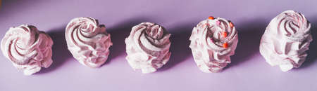 Fresh marshmallows on a purple background. Zephyr, meringue. The concept of home-cooked food,...