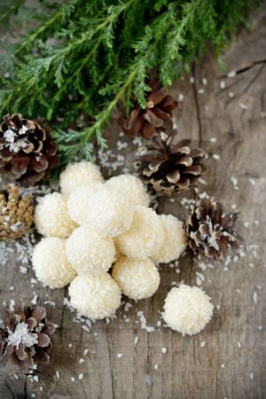 Homemade candies with coconut on wooden tableの写真素材