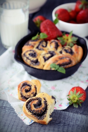 Buns with poppy seeds on a wood tableの写真素材