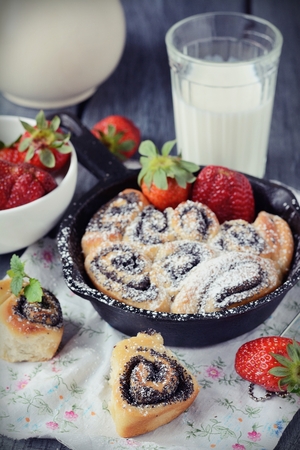 Buns with poppy seeds on a wood tableの写真素材