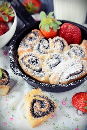 Buns with poppy seeds on a wood tableの写真素材