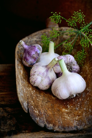 Violet  spring garlic in wooden wooden dipper in rustic styleの写真素材