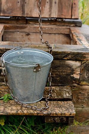 Pail on old well in the Russian northern villageの写真素材
