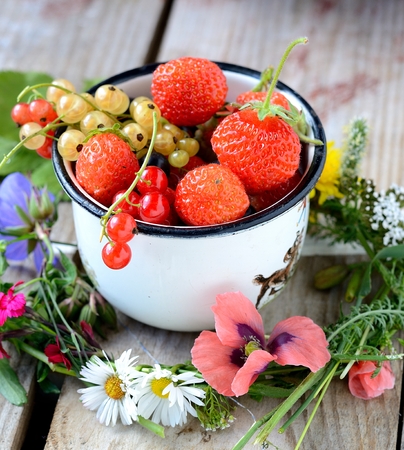 Mug  with fresh berries on black stone background. Rusticの写真素材