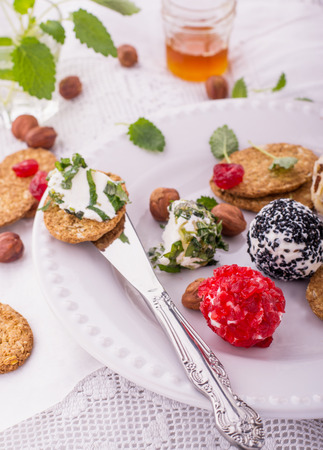 Delicious goat cheese with honey, walnut and crackers on an old wooden cooking board.の写真素材
