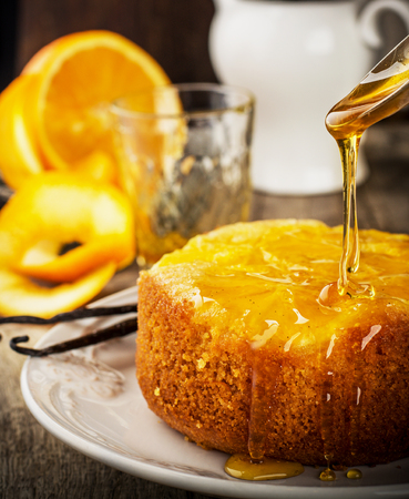 Orange Upside Down Cake with vanilla and honey on wooden background. selective Focusの写真素材