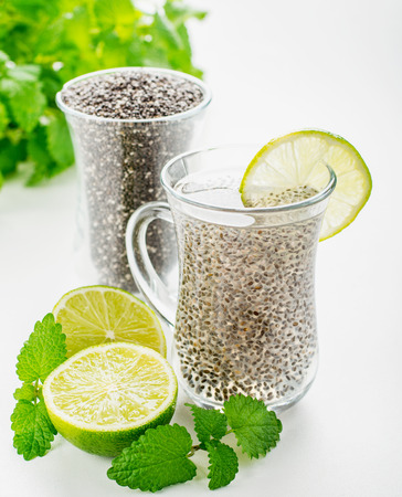 Chia seeds drink with water in transparent glass with lime and lemon balm. selective Focusの写真素材