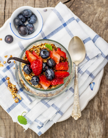 Strawberry, blueberries, oatmeal and chia seeds pudding in a jar for breakfastの写真素材