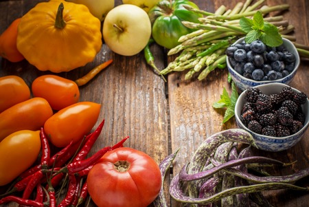 Colorful fresh vegetables of all colors on the wooden background. The concept of healthy nutrition efficiency. Selective focus. Top viewの写真素材