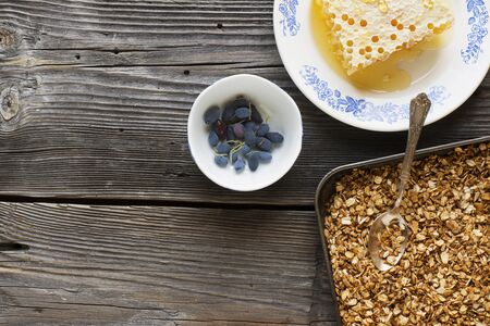 Healthy breakfast. Honey crisp flavorful granola with nuts and berries with fresh floral honey on...