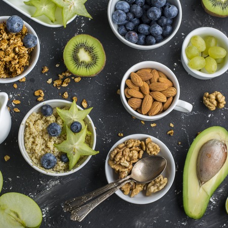 Ingredients for a healthy breakfast,avocado, quinoa bowl, carambola, green apple, banana, kiwi,...