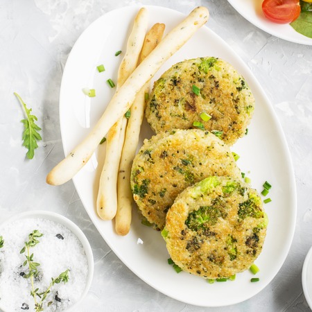Vegetarian meatballs from quinoa and broccoli with fresh lettuce leaves and colorful tomatoes for lunch or healthy snack. Top viewの写真素材