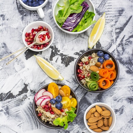Vegetarian Quinoa bowl. Healthy breakfast or snack with detox , tomato, cucumber, carrot,...