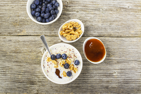 Sweet milk porridge quinoa with honey and walnuts. Top viewの写真素材