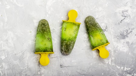 Homemade vegetarian ice cream popsicle fruit citrus peppermint juice with chia seedsの写真素材
