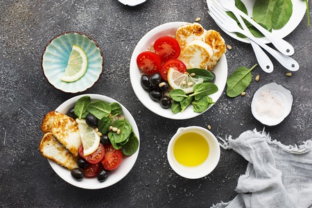 Cheese haloumi brown rice bowl with tomatoes, olives, lemon and pine nutsの写真素材