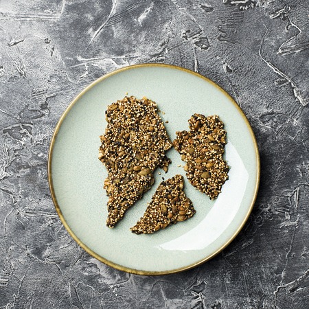 Ketogenic low carbs diet concept. Healthy eating and dieting. Ketogenic kitchen recipes: bread or crackers from seeds without flour, sugar. Quinoa, sesame, pumpkin seeds, sunflower seeds.の写真素材