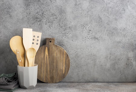 Kitchen shelf gray concrete. Ceramic glass with kitchen spoons, spatulas, measuring spoons. Zero waste house.の写真素材