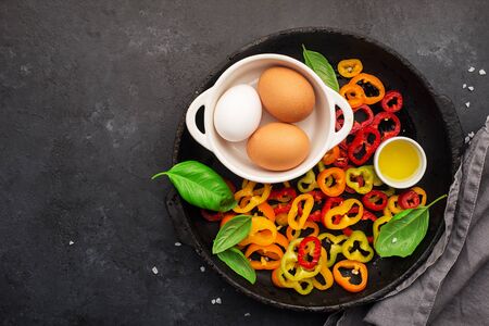 Healthy food nutrition. Ingredients for vegetable wholesome frittata: capsicum pepper, mushrooms, basil, garlic, organic eggs, olive oil. Family breakfast. Top view.の写真素材