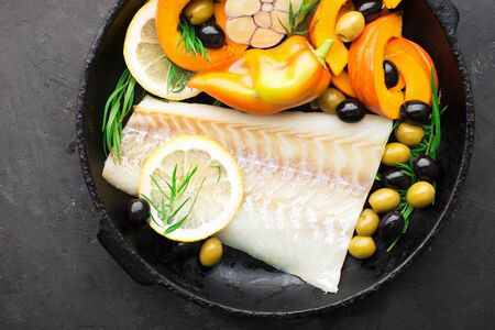 Homemade simple healthy. Farmer market vegetables white cod fish on a baking tray: zucchini, corn,...