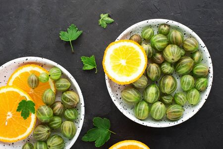 Berries and fruits rich in vitamin C. Garden gooseberries, juicy oranges. Top view. Vitamin Pure Nutrition Diet.の写真素材