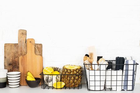 Kitchen shelf lifestyle white background with fresh lemons, pineapple, kitchen tools, appliances,...