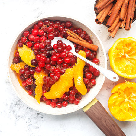 Cranberry orange sauce. Traditional home cooking christmas, thanksgiving recipe for cozy classic food. Cooking ingredients cinnamon, brown sugar, orange juice, red berries. Top view.の写真素材