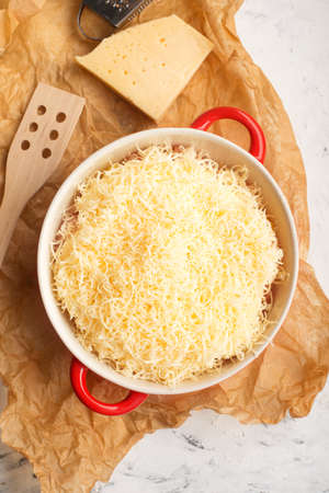Casserole with grated cheese on top. Fish, chicken, pasta, potatoes, vegetables, meat, homemade cozy slow food. Top view.の写真素材